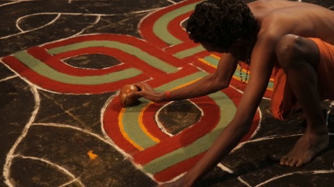 Artist drawing Sarppakalam (Rangoli)