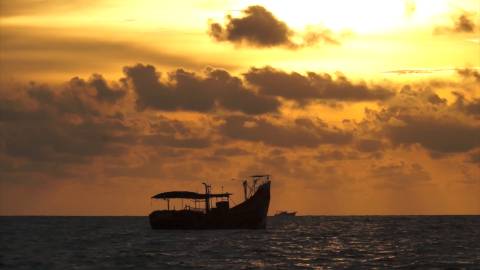 Fishing boat during sunset at sea