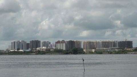 Buildings in a row near a lake