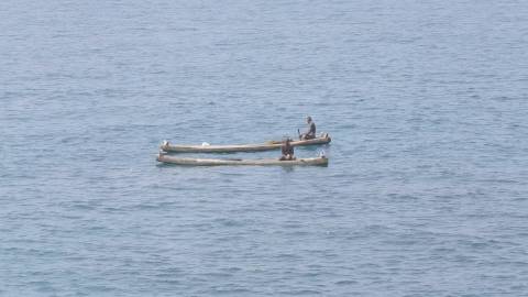 Fishermen aboard Kattumarams in the middle of the sea, Kerala