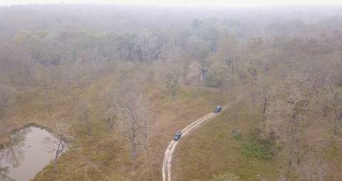 Aerial shot of Jeep safari through Wayanad forest, Kerala