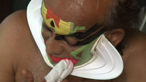 Artist applying Kathakali Makeup