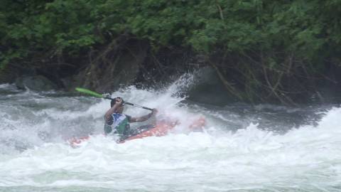Participant kayaking on a tumultuous river