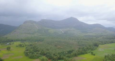 Aerial shot of fields and mountains during monsoon in Kerala