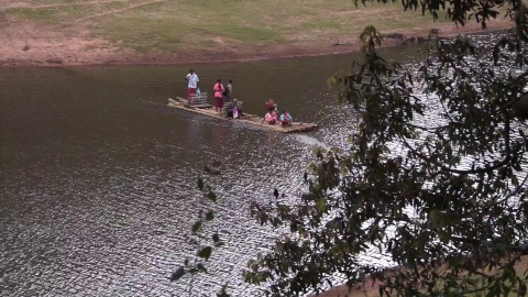 People using bamboo rafts to cross Periyar Lake