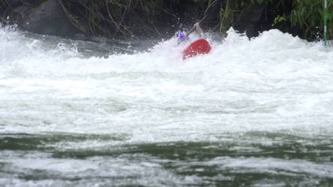 Adventure seeker engaged in river kayaking