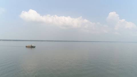 Backwaters with distant clouds and houseboats in Kerala