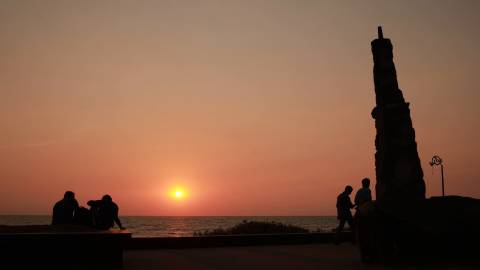 Sunset timelapse with people along the beach