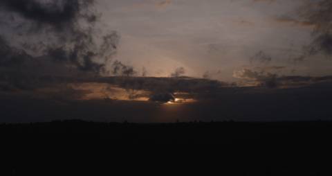 Dark grey clouds obscuring the sun