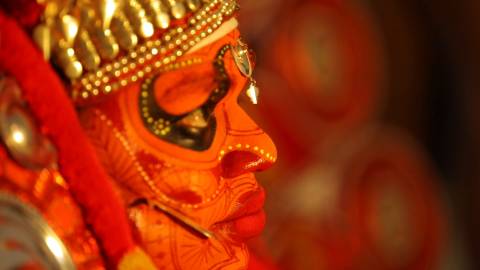 Close up shot of a Theyyam artist's face