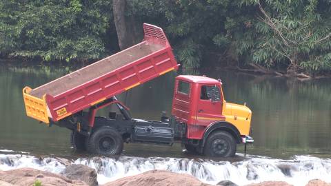 Tipper Lorry parked across a river stream