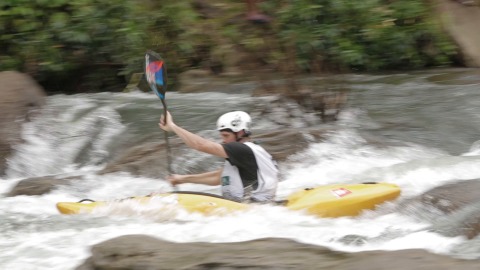Woman kayaking down a river